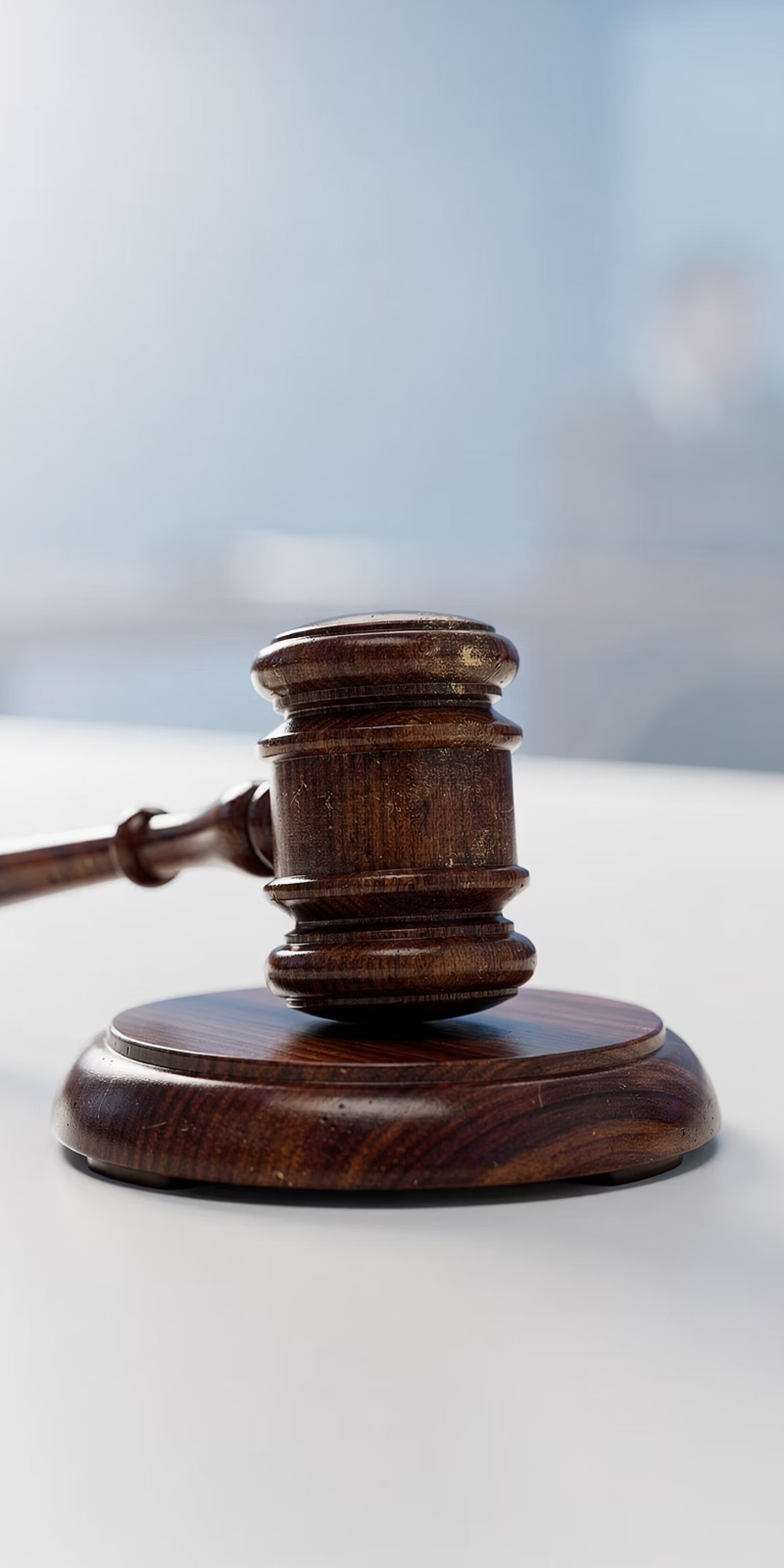A wooden gavel resting on its sound block.
